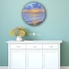 A sunset to remember seascape painting above cupboard